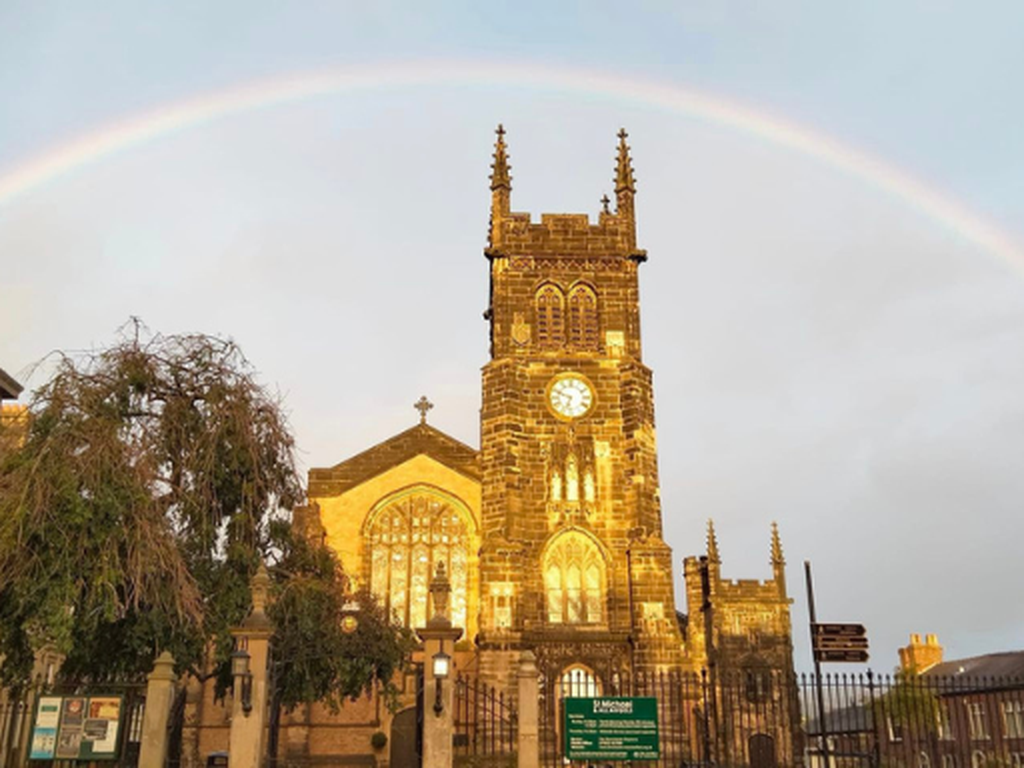Photo of St Michael's Church with a rainbow